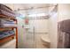 The bathroom features a glass door shower, seat, and mosaic tiles, with a window for natural light at 4616 E Idaho Ave, Las Vegas, NV 89104