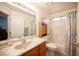 Bathroom with a marble vanity, oak cabinets and a shower over tub at 4616 E Idaho Ave, Las Vegas, NV 89104