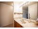 The bathroom features a modern sink, vanity, mirror with vanity lights, and two rustic floating shelves at 4616 E Idaho Ave, Las Vegas, NV 89104