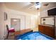 This bedroom features a ceiling fan, closet, mounted television, and a vintage looking safe at 4616 E Idaho Ave, Las Vegas, NV 89104