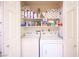 The laundry room features a washer and dryer, with storage shelves above for extra household supplies at 4616 E Idaho Ave, Las Vegas, NV 89104