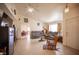 Comfortable living room featuring tile floors, a ceiling fan, and natural light at 4616 E Idaho Ave, Las Vegas, NV 89104