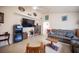 Open-concept living room with neutral walls, tile flooring, and ample natural light at 4616 E Idaho Ave, Las Vegas, NV 89104