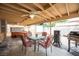 This covered patio features an outdoor dining area, ceiling fan, and grill for outdoor entertaining at 4616 E Idaho Ave, Las Vegas, NV 89104