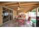 This covered patio features a ceiling fan, table and chairs, with a hot tub for outdoor relaxation at 4616 E Idaho Ave, Las Vegas, NV 89104