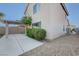 Exterior view showcasing the backyard with a covered patio and landscaping at 4751 Lone Grove Dr, Las Vegas, NV 89139