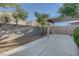Backyard space with a covered patio and trees, perfect for outdoor activities at 4751 Lone Grove Dr, Las Vegas, NV 89139