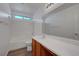 Bathroom featuring a shower-tub combo, wood cabinets, and ample counter space at 4751 Lone Grove Dr, Las Vegas, NV 89139