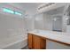 Bright bathroom boasts a vanity, soaking tub, and a large mirror for added appeal at 4751 Lone Grove Dr, Las Vegas, NV 89139