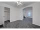 Bedroom featuring neutral walls, carpeting, ceiling fan and an open closet with doorway at 4751 Lone Grove Dr, Las Vegas, NV 89139