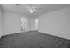 A spacious bedroom with neutral paint, soft carpet, and a doorway to another room at 4751 Lone Grove Dr, Las Vegas, NV 89139