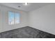 Carpeted bedroom with window providing natural light and views at 4751 Lone Grove Dr, Las Vegas, NV 89139