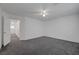 A roomy bedroom with neutral walls and carpeting, and a view into the hallway at 4751 Lone Grove Dr, Las Vegas, NV 89139