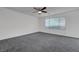 Spacious bedroom featuring neutral walls, gray carpeting and window for natural light at 4751 Lone Grove Dr, Las Vegas, NV 89139