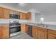 This open kitchen has stainless steel appliances, gray countertops, and gray floors at 4751 Lone Grove Dr, Las Vegas, NV 89139