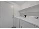 Bright laundry room with a washer, dryer, and a shelf for storage at 4751 Lone Grove Dr, Las Vegas, NV 89139