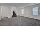Inviting living room with gray carpet, a stairway, and a bright, open layout at 4751 Lone Grove Dr, Las Vegas, NV 89139