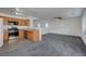Open-concept living room showcasing kitchen with modern appliances and an island at 4751 Lone Grove Dr, Las Vegas, NV 89139