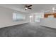 Open concept living room with plush carpeting, sliding glass door and view of the kitchen at 4751 Lone Grove Dr, Las Vegas, NV 89139