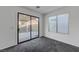 Living room with plush carpeting, large sliding doors with view of patio and natural light at 4751 Lone Grove Dr, Las Vegas, NV 89139
