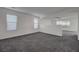 Spacious living room boasts lots of natural light and neutral gray carpeting at 4751 Lone Grove Dr, Las Vegas, NV 89139