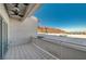 This tiled balcony features a ceiling fan for comfort and views of the nearby mountains and rooftops at 483 Marina Cv, Boulder City, NV 89005