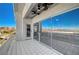 Relax on the tiled balcony featuring a ceiling fan and picturesque views of the water and mountains beyond at 483 Marina Cv, Boulder City, NV 89005