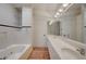 Bright bathroom featuring a soaking tub, white tile, and double sink vanity with ample lighting at 483 Marina Cv, Boulder City, NV 89005