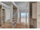 Bedroom closet with built in storage and sliding mirror doors to a bedroom and balcony beyond at 483 Marina Cv, Boulder City, NV 89005