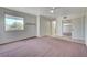 Bright bedroom with ceiling fan, neutral walls, carpet flooring, and closet with sliding mirror doors at 483 Marina Cv, Boulder City, NV 89005