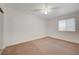 A bright bedroom features light-colored walls, carpet flooring and sliding glass door at 483 Marina Cv, Boulder City, NV 89005