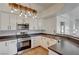 Bright kitchen features stainless steel appliances, white cabinets and modern fixtures at 483 Marina Cv, Boulder City, NV 89005