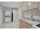 Laundry room showcasing sink, cabinetry, washer and dryer hookups, plus tile flooring and open shelving at 483 Marina Cv, Boulder City, NV 89005
