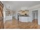 Open-concept living room with hardwood floors, modern lighting, and access to a modern kitchen with white cabinets at 483 Marina Cv, Boulder City, NV 89005