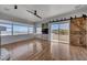Bright living room features hardwood floors, a ceiling fan, built-in cabinets and access to a private balcony with mountain views at 483 Marina Cv, Boulder City, NV 89005