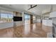 Spacious living room features hardwood floors, a ceiling fan, and sliding barn doors, flowing into a modern kitchen at 483 Marina Cv, Boulder City, NV 89005