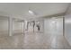 A spacious living room featuring tile floors and multiple entries into the kitchen and rooms at 483 Marina Cv, Boulder City, NV 89005