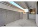 A private patio space featuring concrete flooring, gated access, and stucco wall construction at 483 Marina Cv, Boulder City, NV 89005