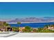 Enjoy lake views and a stunning mountain backdrop from this neighborhood setting with lush landscaping at 483 Marina Cv, Boulder City, NV 89005