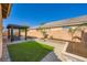 A backyard with artificial turf and desert landscaping at 5817 Pirate Ship Dr, North Las Vegas, NV 89031