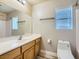 Bright bathroom featuring a modern vanity, large mirror, and a pristine white toilet at 5817 Pirate Ship Dr, North Las Vegas, NV 89031