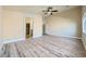 Large bedroom with wood-look floors, ceiling fan, and access to an ensuite bath, blending comfort and convenience at 5817 Pirate Ship Dr, North Las Vegas, NV 89031