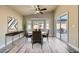 Dining room with gray wood floors and a sliding door at 5817 Pirate Ship Dr, North Las Vegas, NV 89031