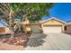 Charming single-story home featuring a well-maintained yard, two-car garage and desert landscaping at 5817 Pirate Ship Dr, North Las Vegas, NV 89031