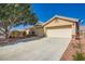 Charming single-story home featuring a well-maintained yard, two-car garage and desert landscaping at 5817 Pirate Ship Dr, North Las Vegas, NV 89031