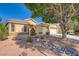 Charming single-story home featuring a well-maintained yard, two-car garage and desert landscaping at 5817 Pirate Ship Dr, North Las Vegas, NV 89031