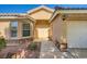Inviting single-story home with a stone-accented facade, well-manicured landscaping and a two-car garage at 5817 Pirate Ship Dr, North Las Vegas, NV 89031