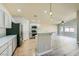 Open kitchen with stainless steel appliances and white cabinets at 5817 Pirate Ship Dr, North Las Vegas, NV 89031