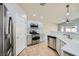 Updated kitchen with stainless steel appliances and white cabinetry at 5817 Pirate Ship Dr, North Las Vegas, NV 89031