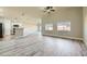 Bright, open living room with hardwood floors, neutral walls, and an adjacent kitchen at 5817 Pirate Ship Dr, North Las Vegas, NV 89031